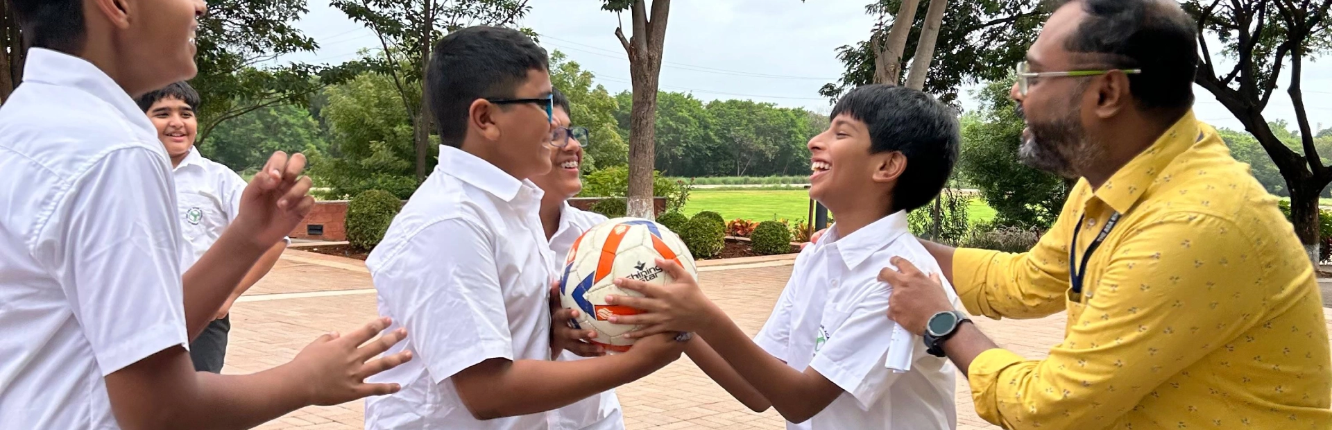 Teacher playing with students during a break in the school day.